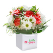 A sense of joy and anticipation radiates from this Northwood bouquet, where coral and peach carnations bloom exuberantly alongside lively white daisies with bright, lime-touched centers. Each petal is soft-edged and plush, inviting the hand, while sprays of white baby's breath lift and dot the scene with weightless beauty-reminiscent of the tranquil, airy feeling you find on a walk through Frithwood or the greenery near Eastbury. Deep, glossy leaves create a lush, embracing base, forming a natural skirt around the vibrant flowers, while the hint of unopened, purple-blushed buds on the left adds a quiet sense of unfolding possibility. Carefully arranged and upright within a spotless white gift bag with sturdy handles, the bouquet is visually isolated against immaculate white-drawing all focus to its abundant shape and colour. Ready to be delivered across Northwood for any joyful moment or simply as a kind surprise, this bouquet embodies the skill and heart of a local Northwood florist, reflecting timeless gestures of appreciation, friendship, and celebration. Every detail is a reflection of fresh beginnings and shared happiness-perfect for bringing a little bit of Northwood's natural charm into someone's day.